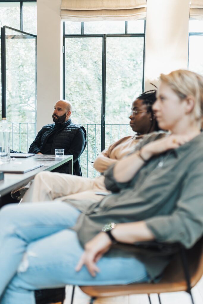 pexels photo 18999456 18999456 Focused individuals during a business meeting in an office with large windows.
