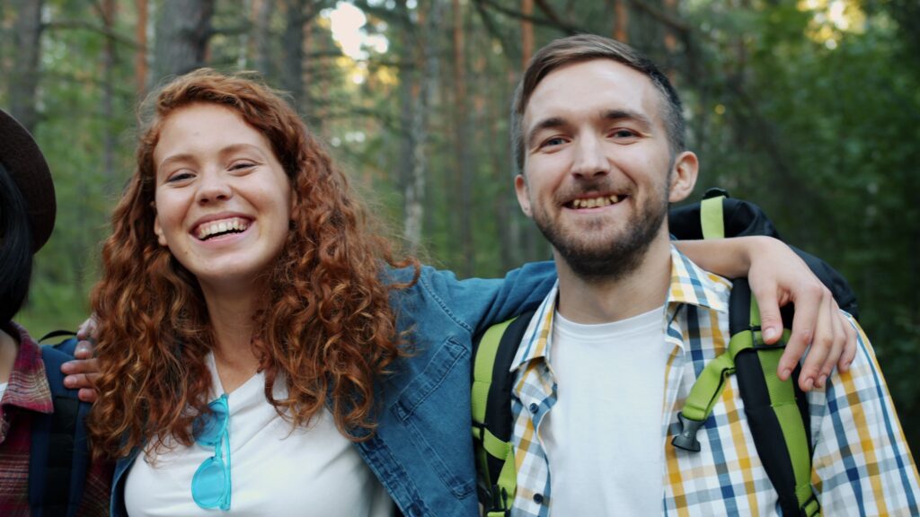pexels photo 36713495 36713495 Two friends smiling during a forest hike, enjoying nature and friendship.