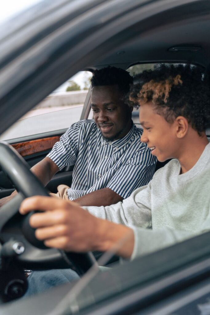 pexels photo 9518021 Father and teenage son sitting in a car, bonding while learning to drive.